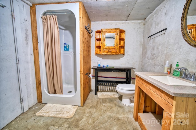 bathroom with toilet, vanity, concrete floors, and a shower with shower curtain