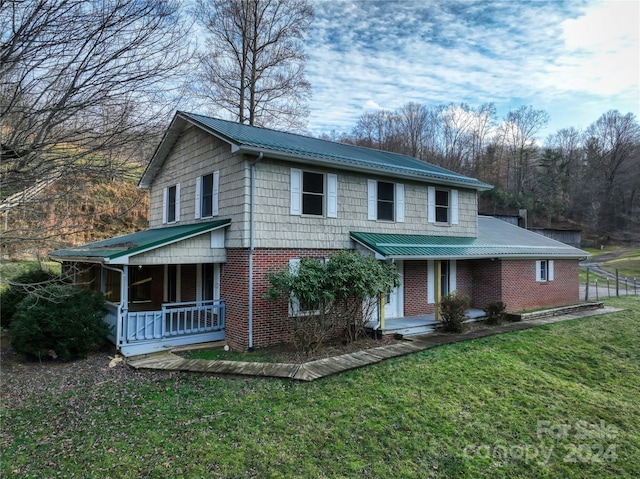 front facade featuring a porch and a front yard