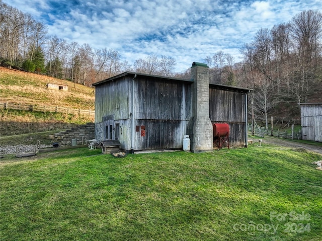 view of outbuilding with a yard