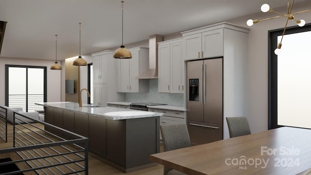 kitchen with white cabinetry, stainless steel fridge with ice dispenser, a center island with sink, and sink