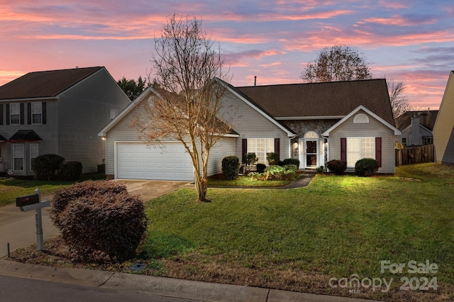 view of front of home with a lawn and a garage