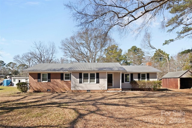 ranch-style house with a storage shed and a front yard