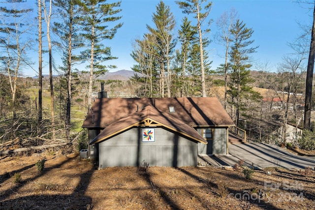 view of front of house featuring a mountain view and cooling unit