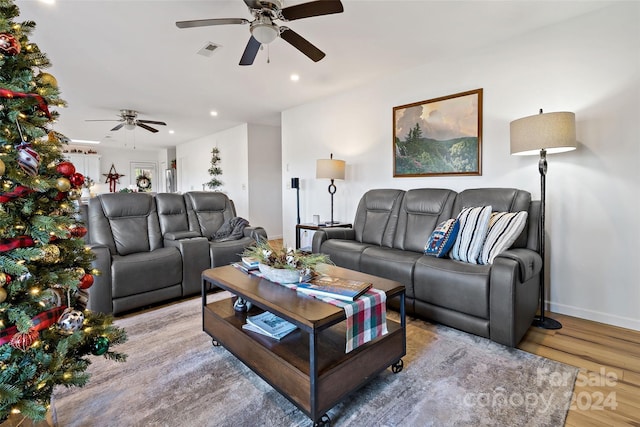 living room featuring hardwood / wood-style floors and ceiling fan