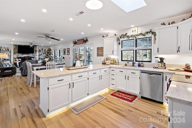 kitchen featuring kitchen peninsula, white cabinetry, and dishwasher