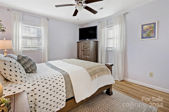 bedroom with ceiling fan and hardwood / wood-style flooring