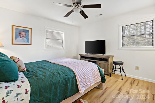 bedroom with light wood-type flooring and ceiling fan