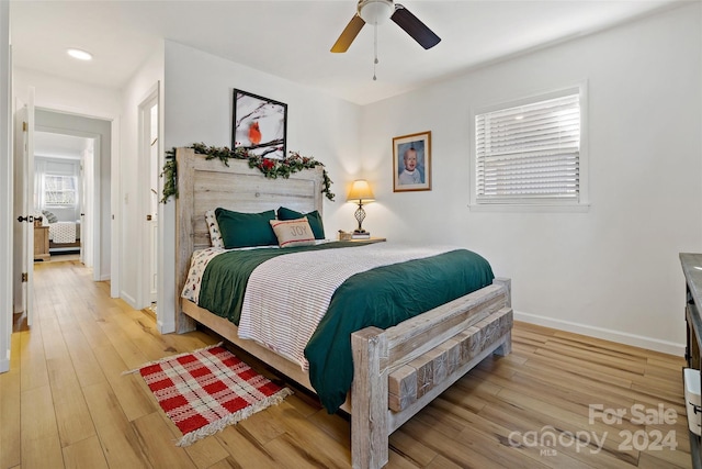 bedroom with ceiling fan and light hardwood / wood-style flooring