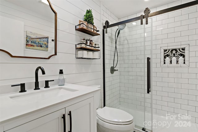 bathroom with vanity, wood walls, toilet, and a shower with door