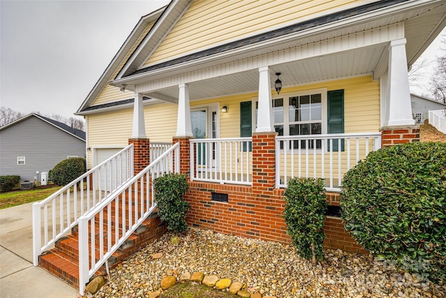 property entrance with central AC unit and a porch