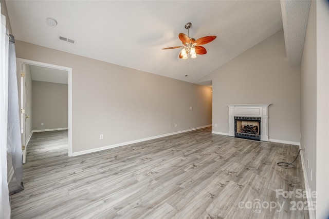 unfurnished living room featuring ceiling fan, light hardwood / wood-style floors, and lofted ceiling