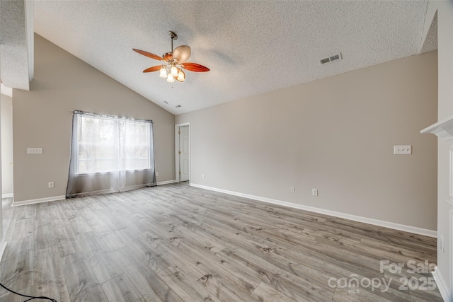 unfurnished room featuring a textured ceiling, light wood-type flooring, high vaulted ceiling, and ceiling fan