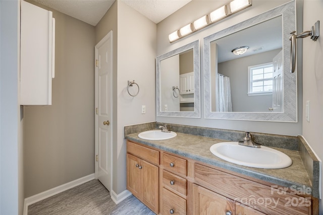 bathroom featuring a textured ceiling, vanity, and hardwood / wood-style flooring