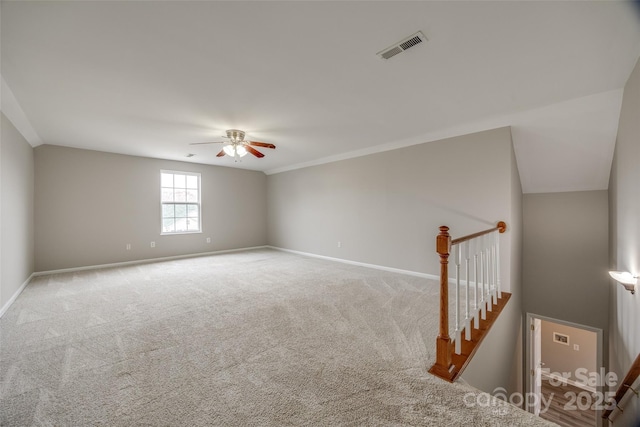 carpeted empty room featuring ceiling fan and ornamental molding