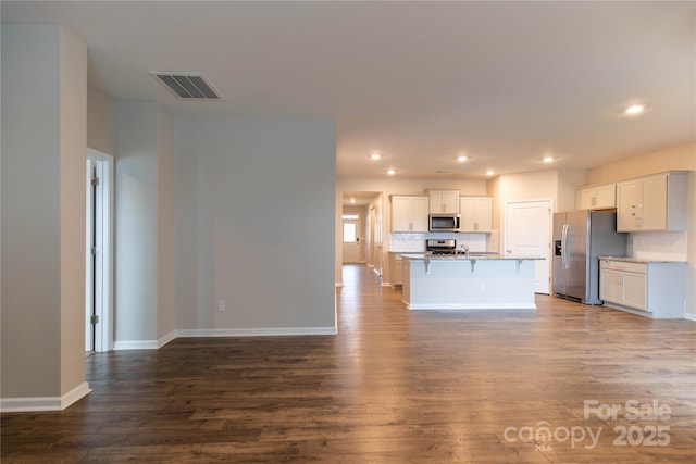 unfurnished living room featuring hardwood / wood-style flooring