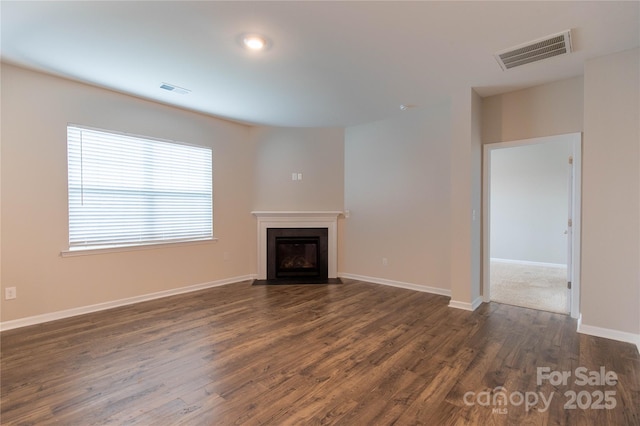 unfurnished living room featuring dark wood-type flooring