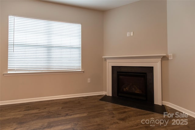 unfurnished living room with dark wood-type flooring