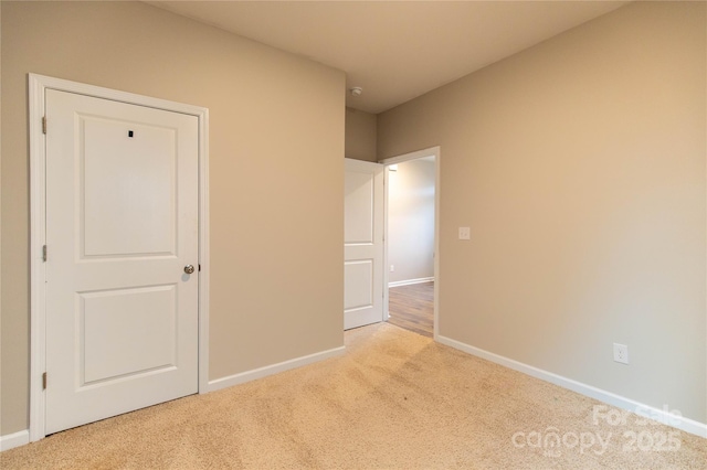 unfurnished bedroom with light colored carpet