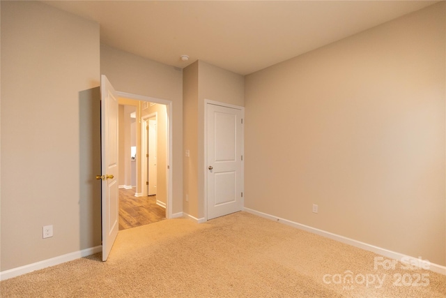 unfurnished bedroom featuring light colored carpet