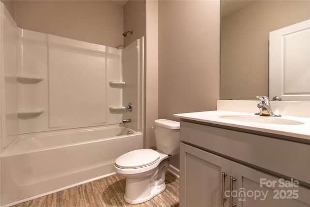 full bathroom with vanity, wood-type flooring, toilet, and washtub / shower combination