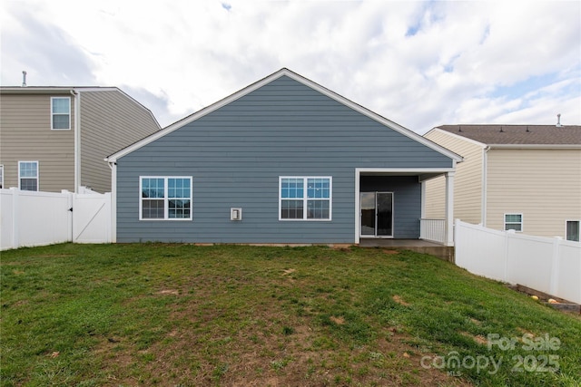 rear view of house with a yard and a patio area