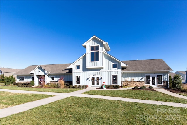 view of front of house with a front yard and french doors