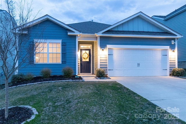 single story home with board and batten siding, a shingled roof, a front yard, driveway, and an attached garage