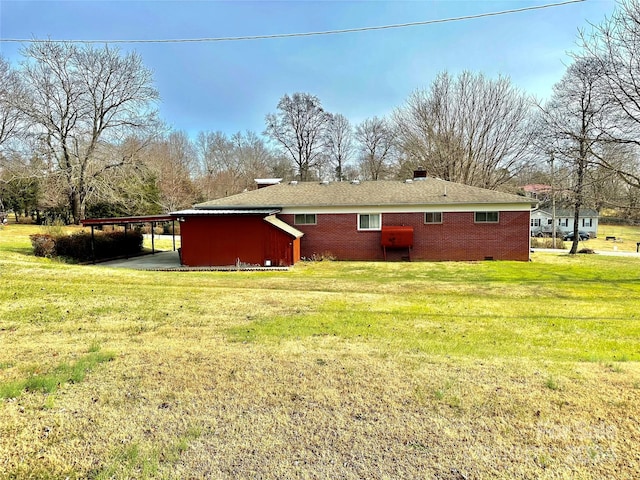 back of house with a yard and a carport