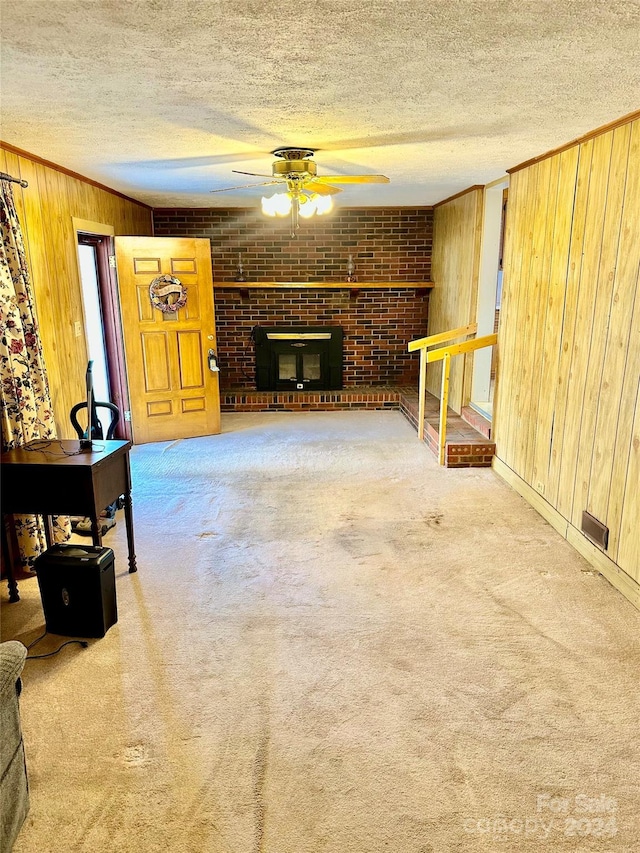 living room with wood walls and carpet floors