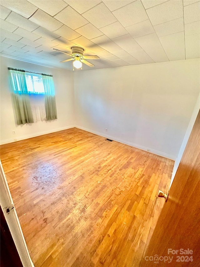 unfurnished room with hardwood / wood-style flooring and ceiling fan