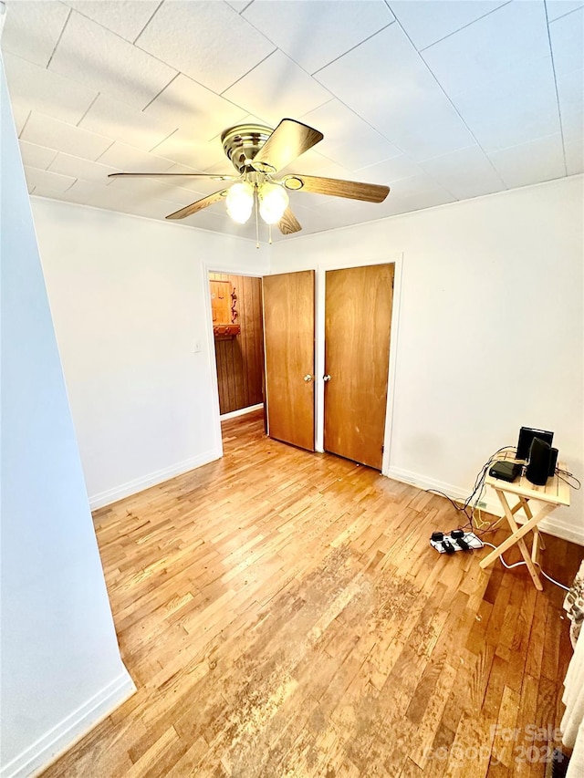 empty room with light hardwood / wood-style flooring and ceiling fan