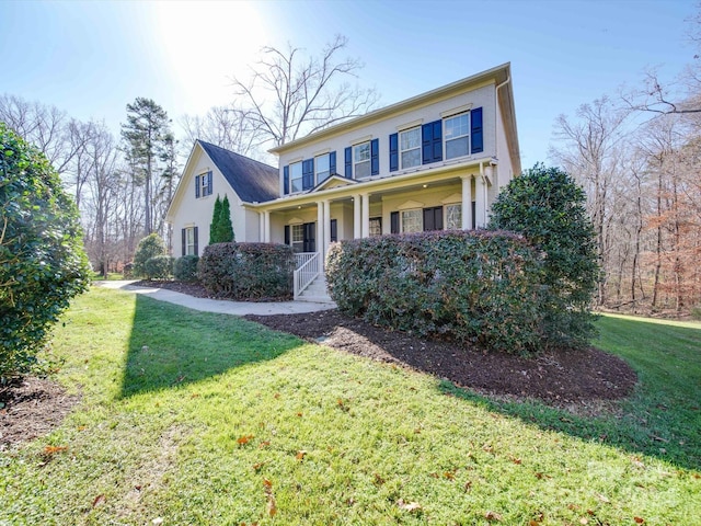 view of front of home featuring a porch and a front lawn