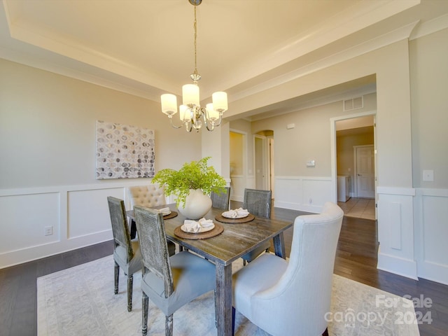 dining area featuring dark hardwood / wood-style floors and an inviting chandelier