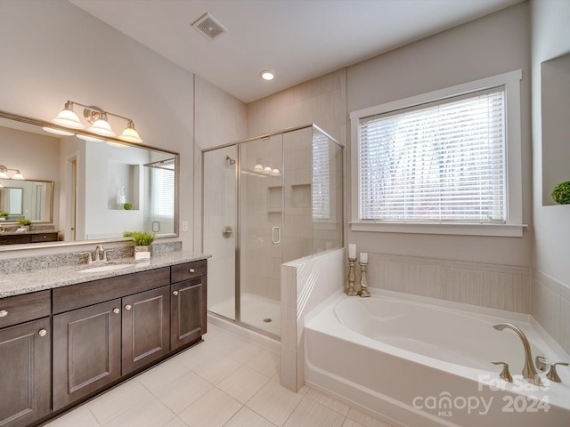 bathroom featuring tile patterned flooring, vanity, and separate shower and tub