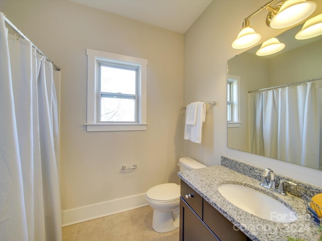 bathroom with tile patterned flooring, vanity, and toilet