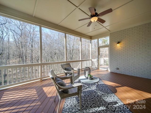 sunroom / solarium with ceiling fan and a healthy amount of sunlight