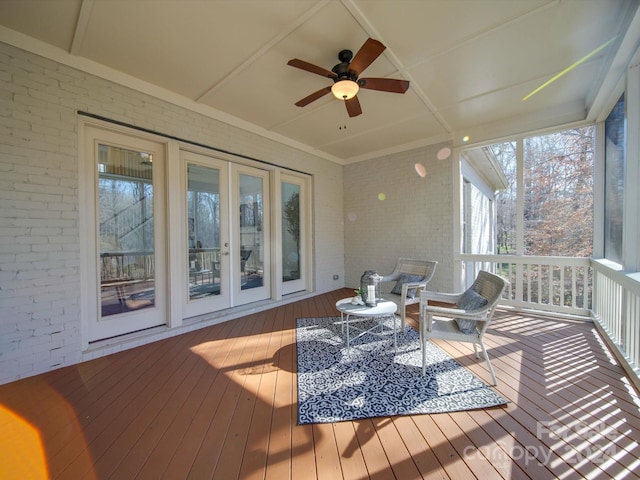 sunroom featuring ceiling fan and a healthy amount of sunlight