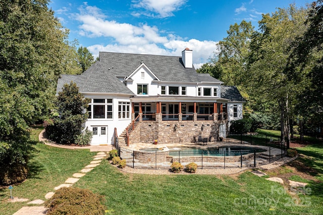 back of house featuring a yard, a fenced in pool, and a patio area