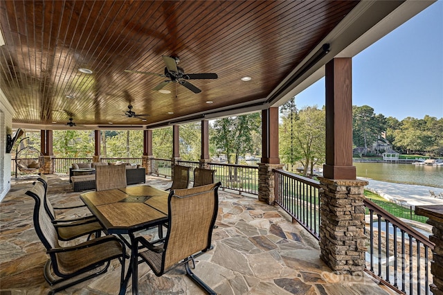 view of patio / terrace featuring ceiling fan and a water view