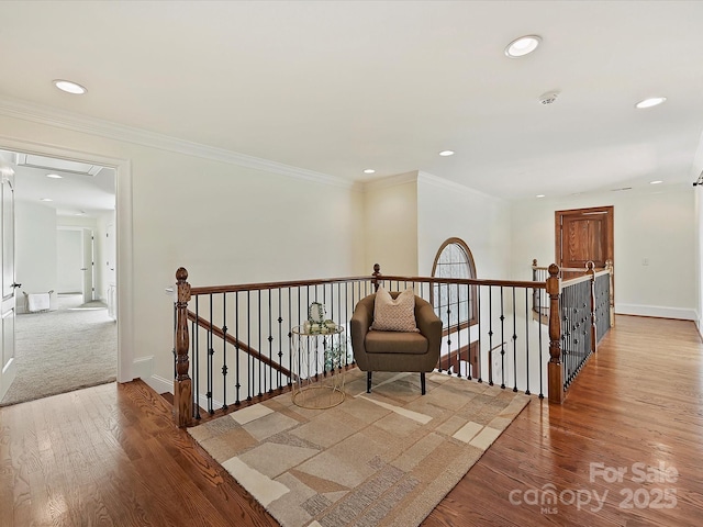 hall featuring light wood-type flooring and crown molding