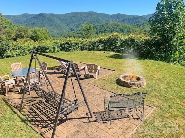 view of patio / terrace featuring a mountain view and an outdoor fire pit