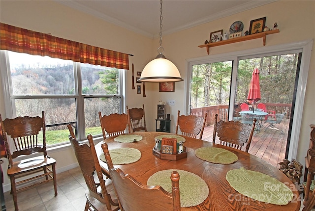 dining area with plenty of natural light and ornamental molding