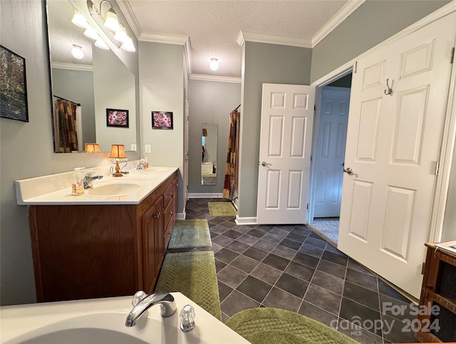 bathroom with crown molding, tile patterned flooring, vanity, and a textured ceiling