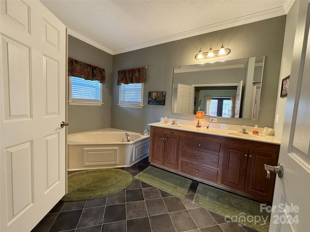 bathroom with tile patterned flooring, vanity, a healthy amount of sunlight, and a textured ceiling