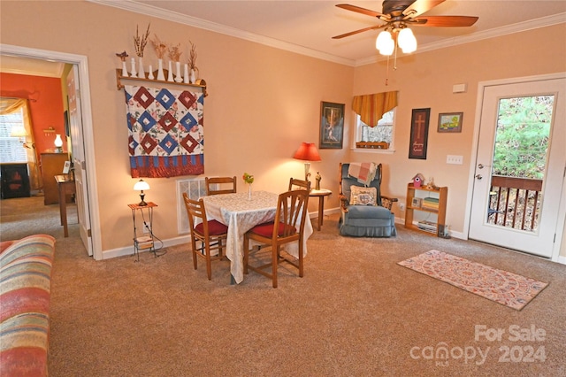 carpeted dining area with ceiling fan and ornamental molding