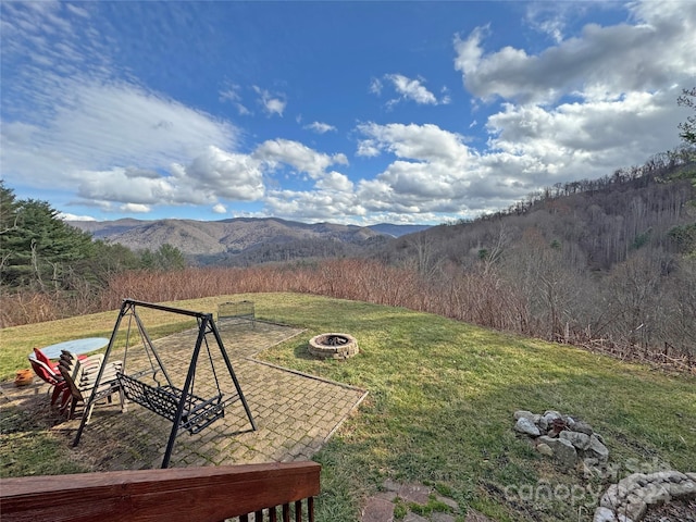 view of yard with a mountain view and an outdoor fire pit