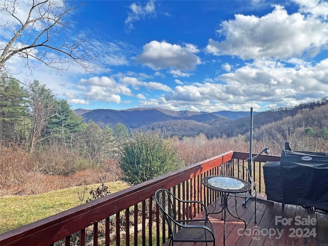 wooden deck featuring grilling area and a mountain view