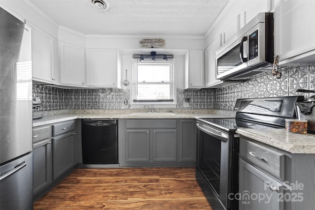 kitchen with black appliances, gray cabinets, and white cabinetry