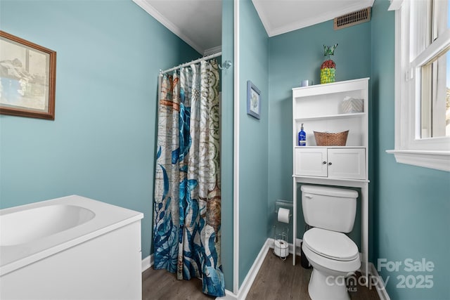 bathroom with a shower with shower curtain, crown molding, sink, hardwood / wood-style flooring, and toilet