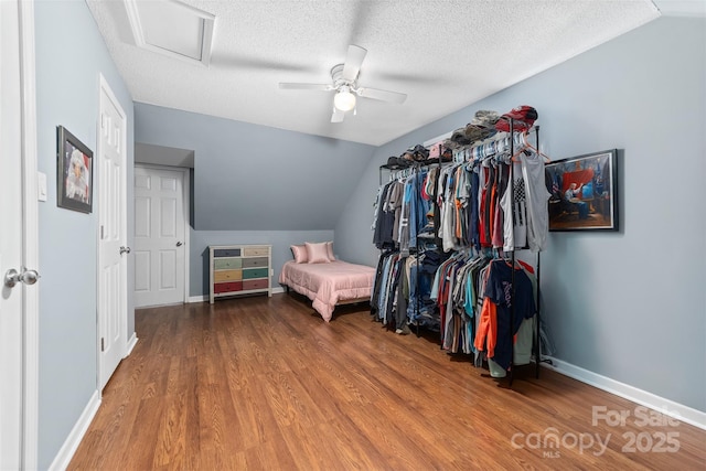 spacious closet featuring hardwood / wood-style floors, ceiling fan, and vaulted ceiling